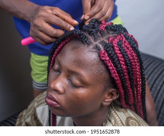 African Lady Making A New Hair Style With The Help Of A Hair Stylist 