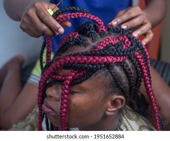 African Lady Making A New Hair Style With The Help Of A Hair Stylist 