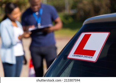 African Learner Driver And Instructor Behind A Car