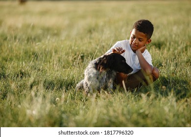 African Little Boy. Child In A Summer Park. Kid Plays With Dog.