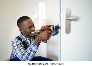 African Locksmith Man Changing And Fixing Door Lock