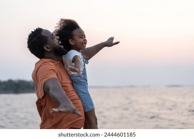 African love family father and daughter enjoying a carefree moment  strength and happiness as he lifts his young daughter, childhood, joy, leisure, parenting and outdoor activities, Father day - Powered by Shutterstock