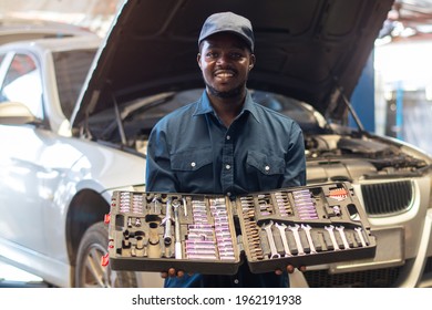 African maintenance male holding a set of car repair tools in box - Powered by Shutterstock