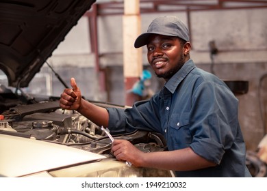 African maintenance male service checking engine system at the garage