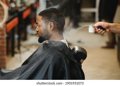 African Male Client Getting Haircut At Barber Shop From Professional Hairstylist.