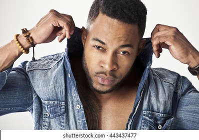 African Male Model Wearing A Jean Shirt Looking Very Serious Holding His Collar