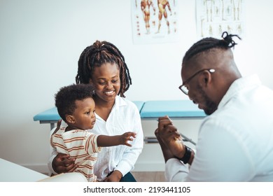 African Male Pediatrician Hold Stethoscope Exam Child Boy Patient Visit Doctor With Mother, Black Paediatrician Check Heart Lungs Of Kid Do Pediatric Checkup In Hospital Children Medical Care Concept