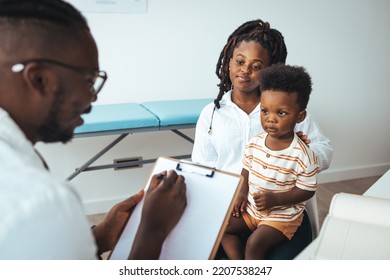 African Male Pediatrician Hold Stethoscope Exam Child Boy Patient Visit Doctor With Mother, Black Paediatrician Check Heart Lungs Of Kid Do Pediatric Checkup In Hospital Children Medical Care Concept