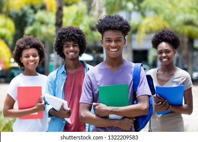 African male student with group of african american students outdoor in the summer