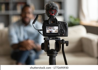 African Man Blogger Sit On Sofa Record New Vlog View Through Digital Camera Screen Close Up. Vlogger Share New Information With Subscribers Using Modern Digital Equipment Webinar Videovlogging Concept