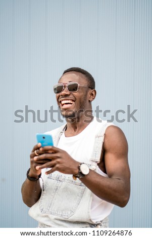 Similar – African man blue background with mobile phone.