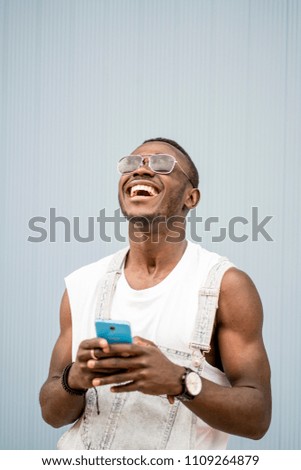 Similar – African man blue background with mobile phone.