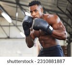 African man, boxing and punch in gym for fitness, focus or training for growth, goal and wellness for competition. African guy, boxer and gloves for exercise, wellness or martial arts club for sports