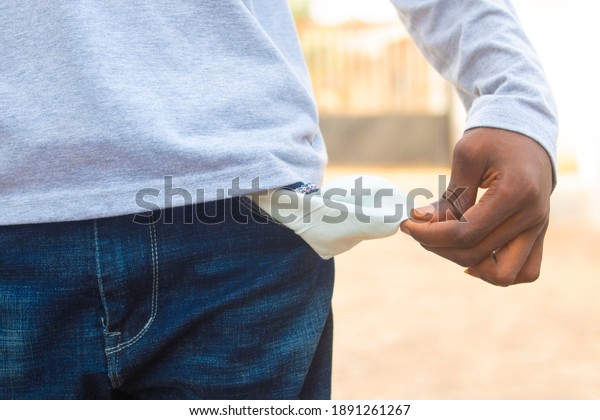 african man drawn out his\
empty pocket.
