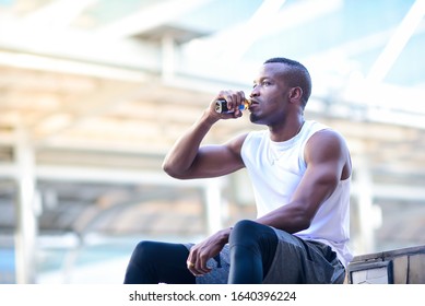 African Man Drinking Energy Drink After Exercise