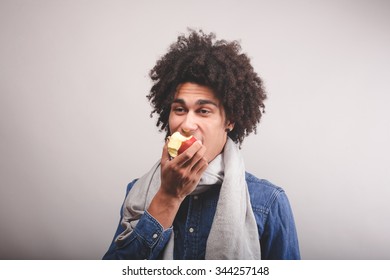 African man eating an apple
