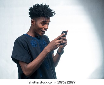 African Man Excited At His Mobile Phone