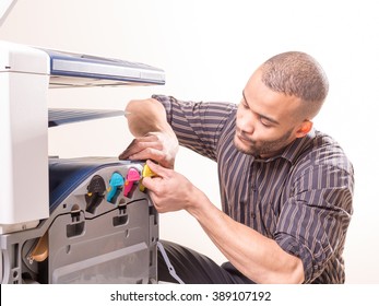 African Man Fixing Photo Copier