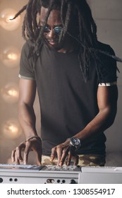 African Man Fixing The Synthesizer. Close Up Photo. Man Writing A Music For Song