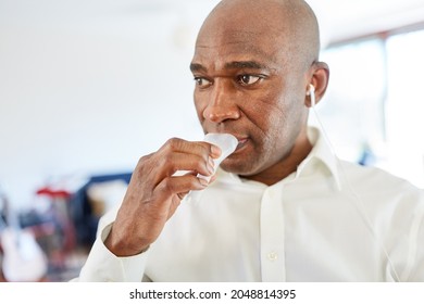 African Man Gives A Saliva Sample For The Coronavirus Rapid Test As A Self-test At Home