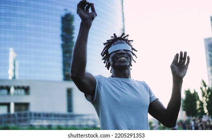 African Man Having Fun Using Augmented Reality Glasses Outdoor - Soft Focus On Virtual Headset