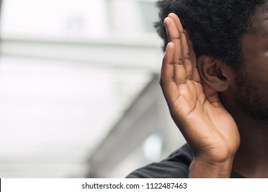 African Man Hearing Or Listening; Portrait Man Listening To Hearsay, Rumor, Gossip, Good Or Bad News; Communication, Information, Rumor Concept; African Man Or Black Man Young Adult Model