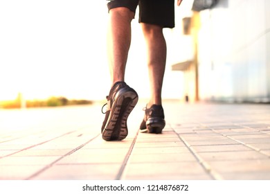 African man legs running while exercising outdoors, at sunrise or sunset. - Shutterstock ID 1214876872