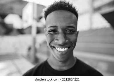 African man looking at camera inside basketball court - Main focus on nose - Black and white editing. - Powered by Shutterstock