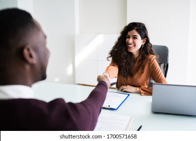 African Man And Middle Eastern Woman Shaking Hands At Interview Meeting 