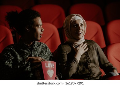 African Man And Muslim Hijab Woman Watch Movie In Cinema