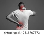 African man with neck and back pain, rubbing his painful body over white background, back view