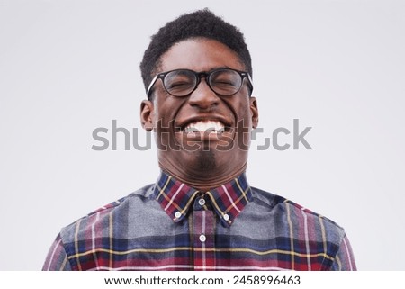 African man, playful and crazy face in studio for emoji, comedy and fun by white background. Black male person, emotions and silly for joke, prank and comic for humour and laugh isolated on backdrop