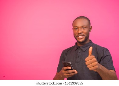 African man pressing his phone and giving thumbs up of approval