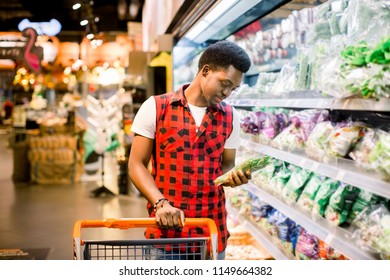 African Man Shopping In Produce Section Of Supermarket