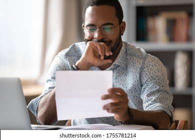 African Man Sit At Desk Hold Postal Correspondence Letter Read Good News Feel Proud By Personal Business Achievement, Got Hired, Receive Reward, Financial Success Statement, Approved Bank Loan Concept