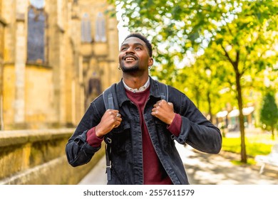 African man smiling while exploring walking down a city