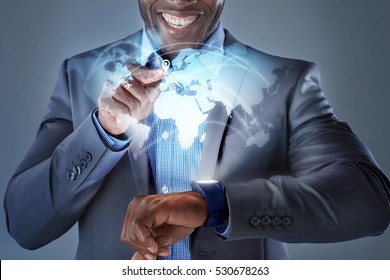 African Man Smiling While Pressing Smartwatch Displaying Globe Hologram Wearable Technology Futuristic Business Travel Concept