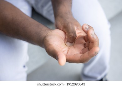 African man suffering from wrist or hand pain, sick black man with CTS, wrist pain, trigger finger, bone arthritis, gout symptoms, De quervain's disease, joint sickness, health care or pain concept