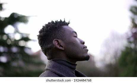 African Man Taking A Deep Breath Outside At Park. Close-up Person Meditating