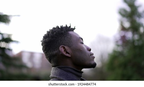 African Man Taking A Deep Breath Outside At Park. Close-up Person Meditating