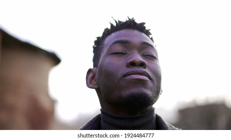 African Man Taking A Deep Breath Outside At Park. Close-up Person Meditating