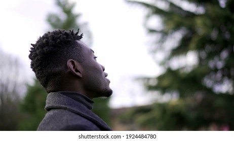 African Man Taking A Deep Breath Outside At Park. Close-up Person Meditating