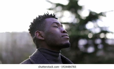 African Man Taking A Deep Breath Outside At Park. Close-up Person Meditating