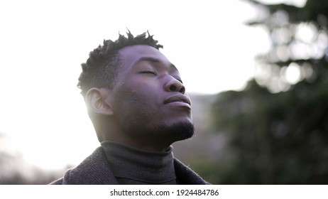 African Man Taking A Deep Breath Outside At Park. Close-up Person Meditating