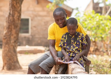 African Man Teaching A Child, Helping With Home Work