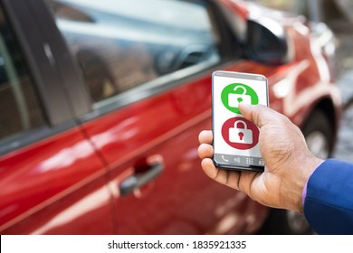 African Man Unlocking Car Using Smartphone App