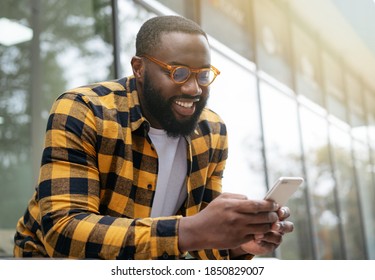 African Man Using Mobile Phone, Shopping Online