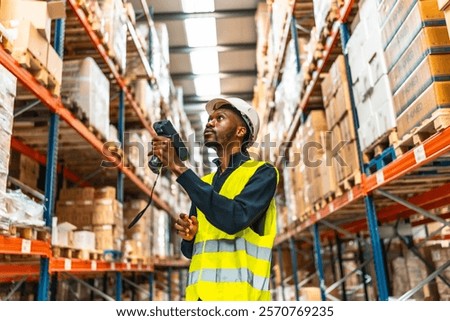 African man using scanner to read the barcodes and check the packages in a warehouse