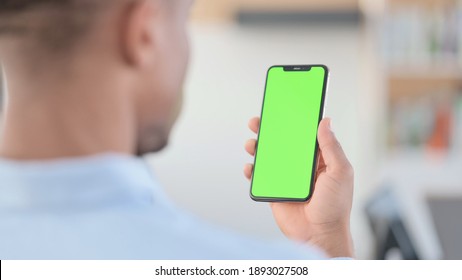 African Man Watching Smartphone with Green Screen - Powered by Shutterstock