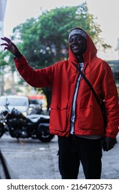 African Man Waving And Smiling In The Street.